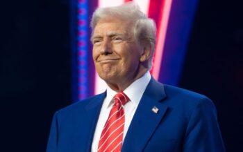 President-elect Donald Trump smiles during Turning Point USA's AmericaFest at the Phoenix Convention Center on December 22, 2024 in Phoenix, Arizona. The annual four day conference geared toward energizing and connecting conservative youth hosts some of the country's leading conservative politicians and activists. (Photo by Rebecca Noble/Getty Images)